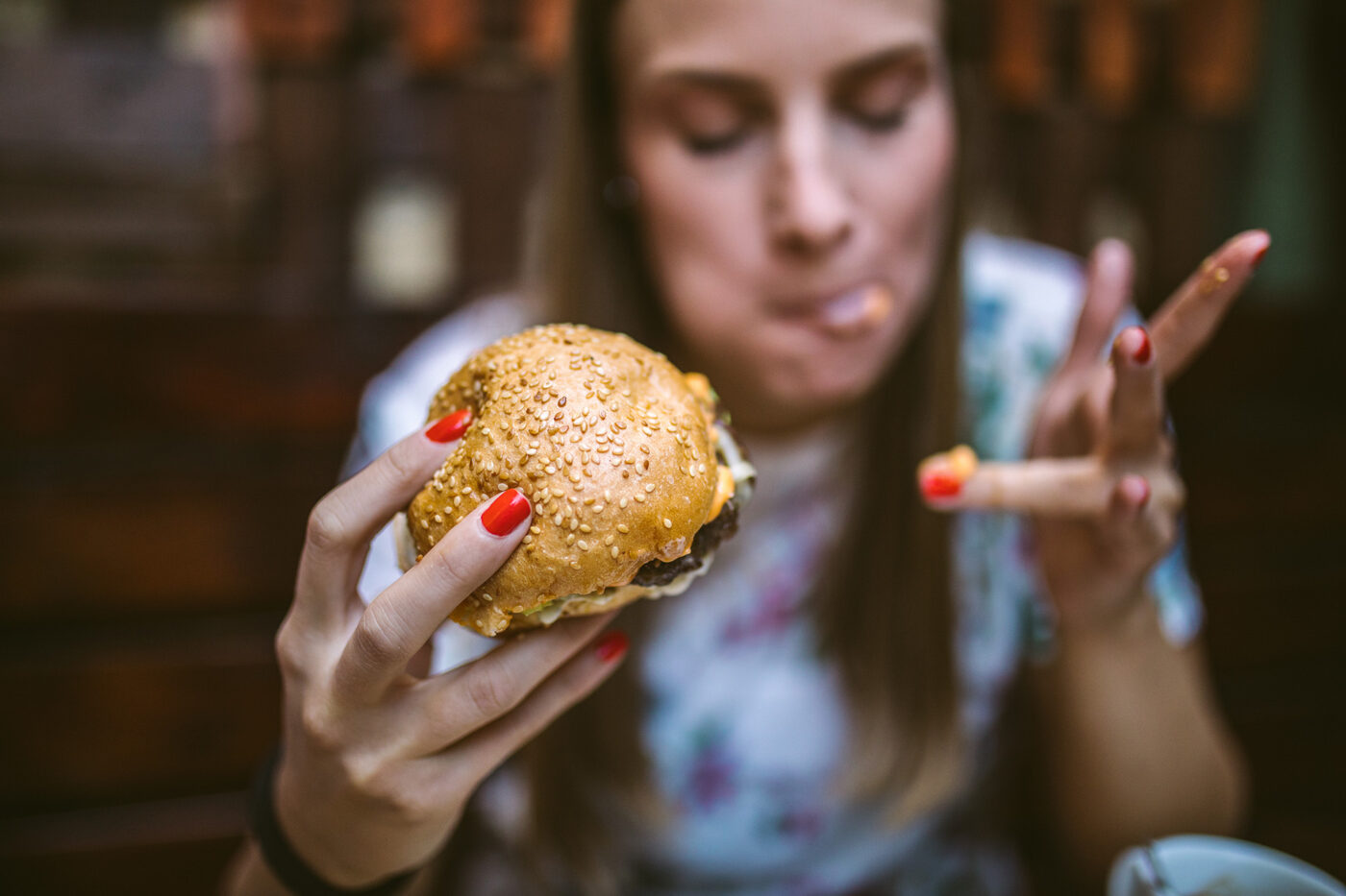 Woman Enjoying Delicious Burger