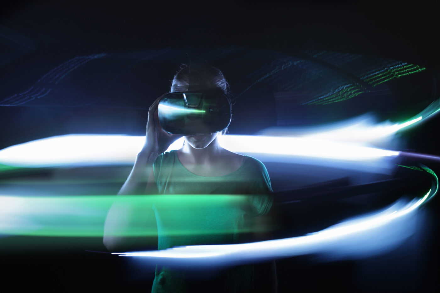 Girl using VR glasses, lights around her